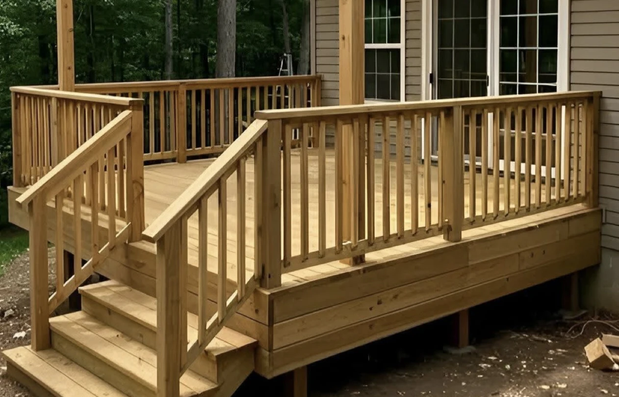 New pressure-treated wood deck with steps and railing