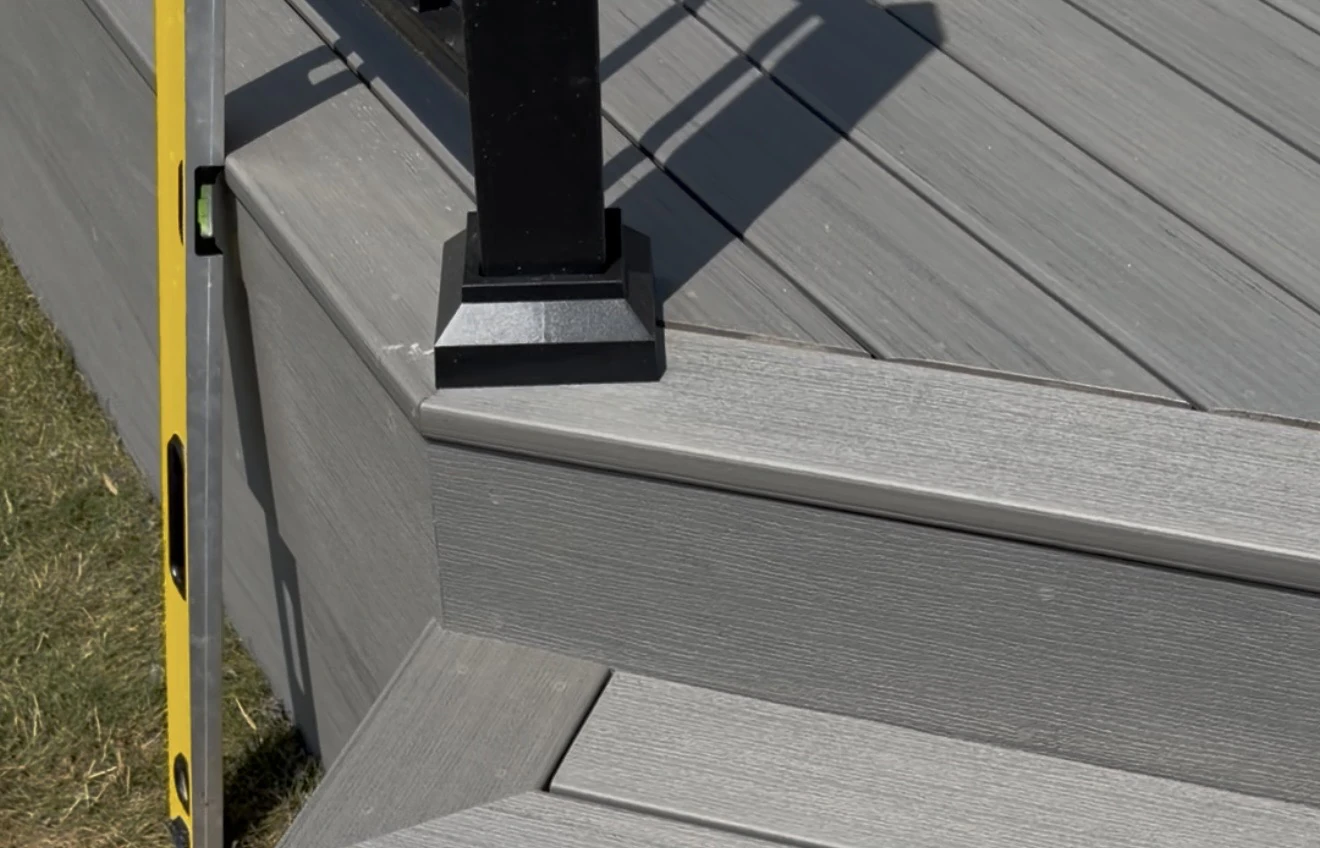 Close-up of grey composite decking around a black post